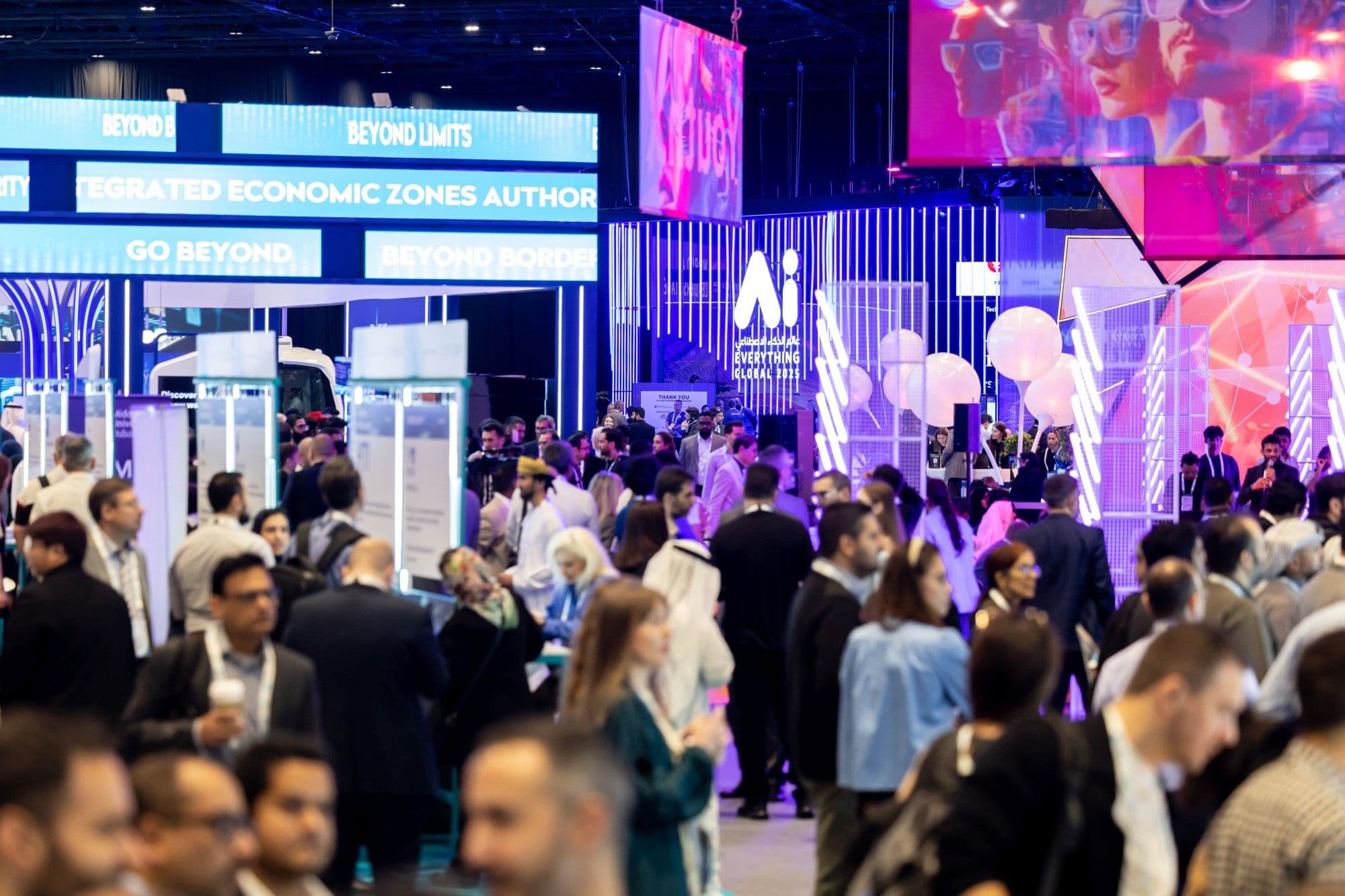 Crowded exhibition hall with illuminated AI displays.