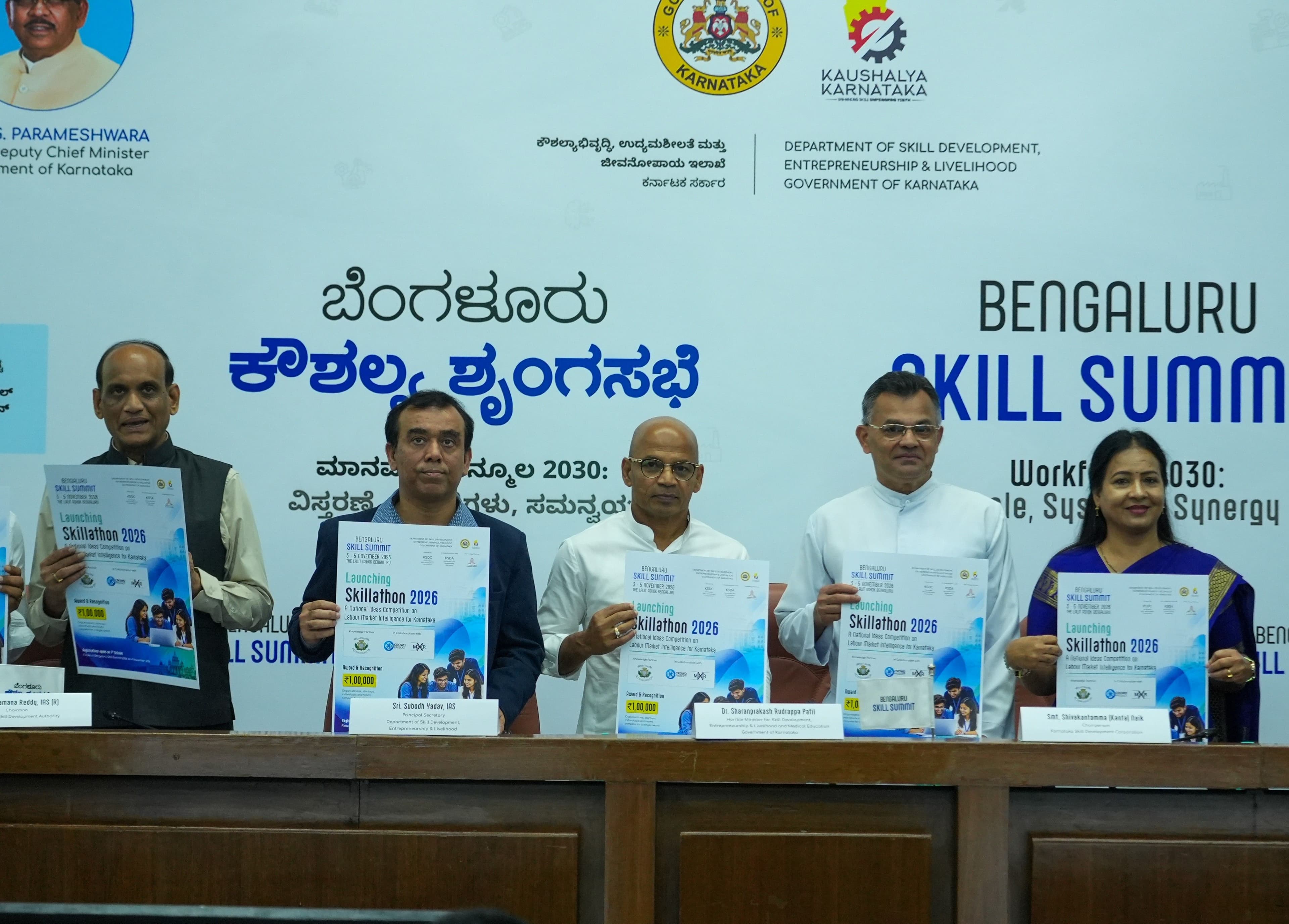 Representatives holding event materials beneath Bengaluru Skill Summit branding.