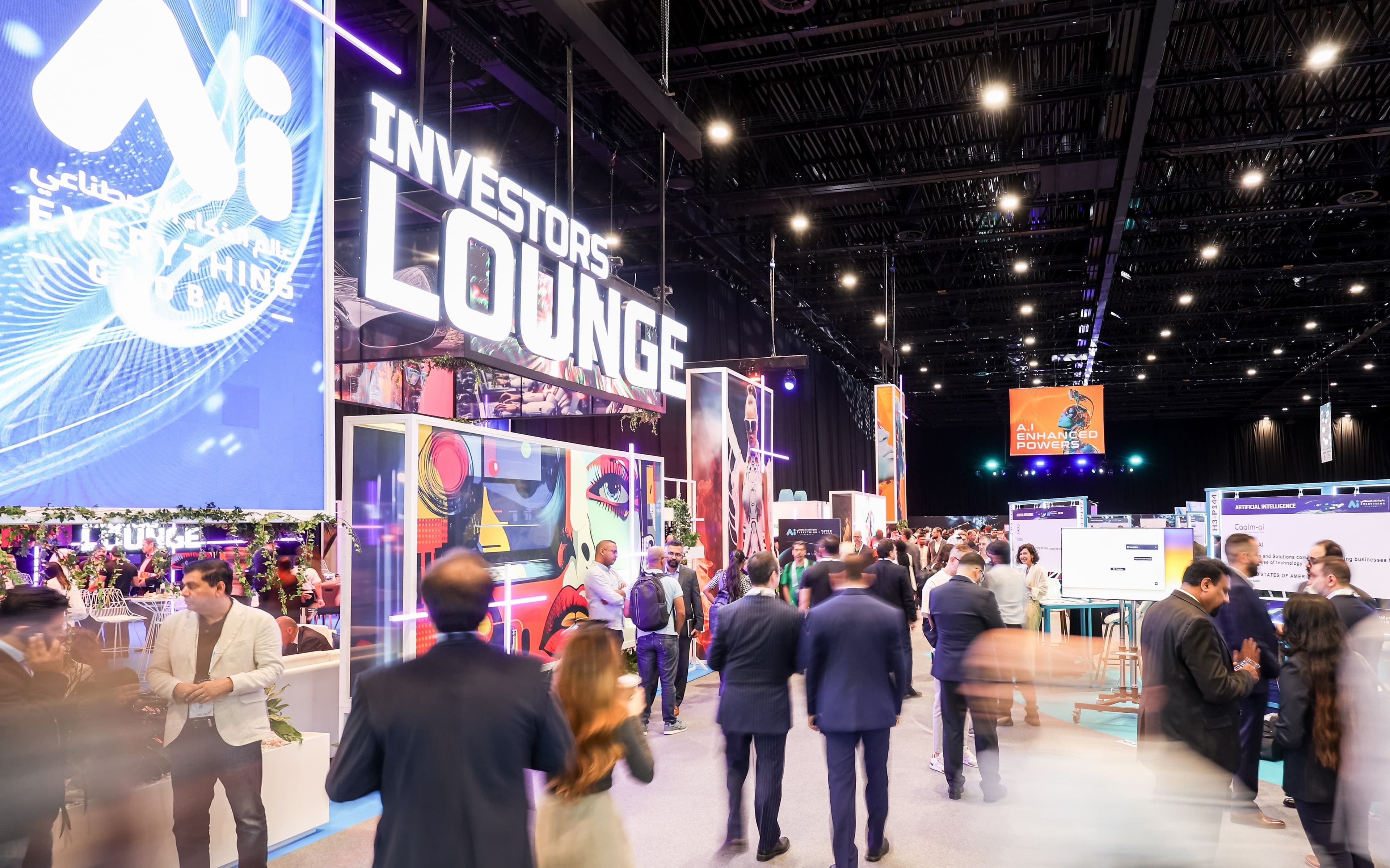 Visitors walking through an AI exhibition near an Investors Lounge sign.