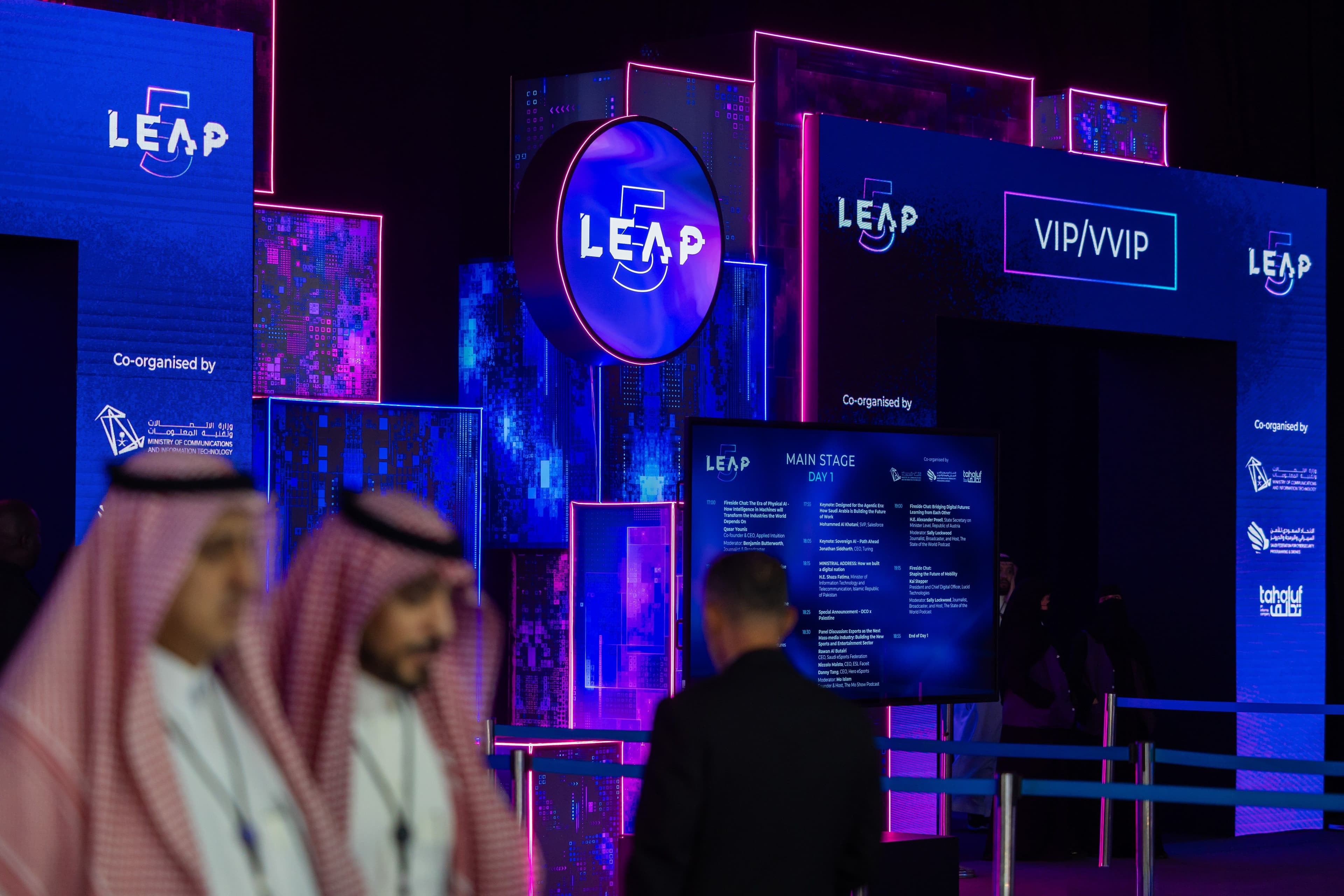 Illuminated LEAP exhibition signs in a conference venue.