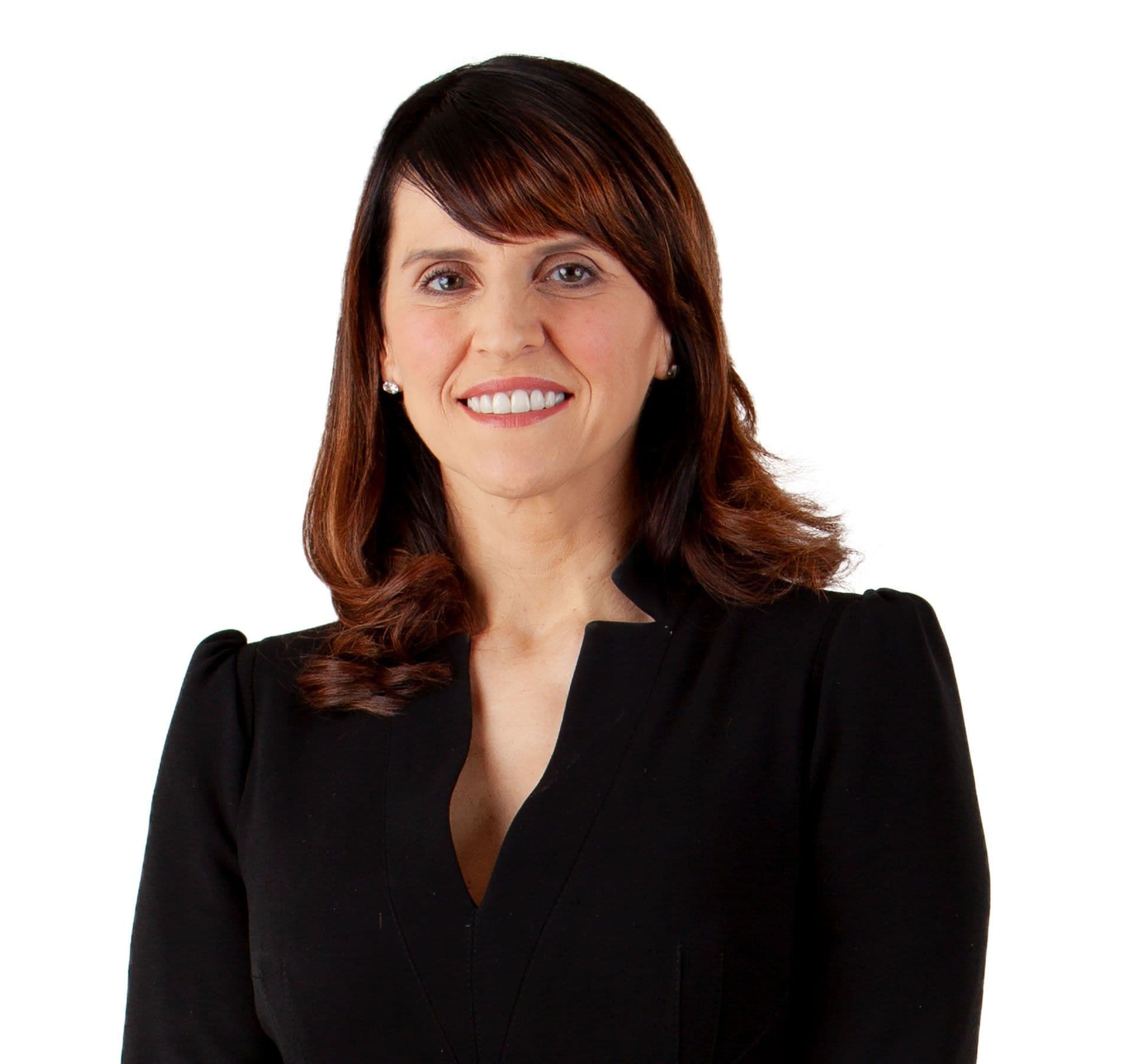Portrait of a smiling woman wearing a black blazer over a light-colored top.