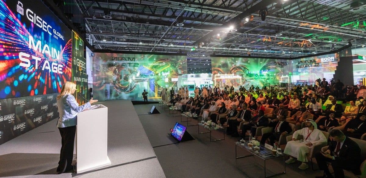 Audience watching a presentation on an exhibition main stage.