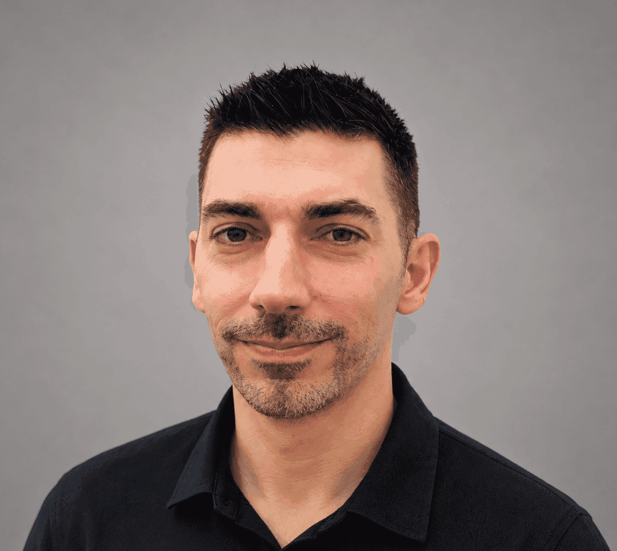 Portrait of a man wearing a black polo shirt.
