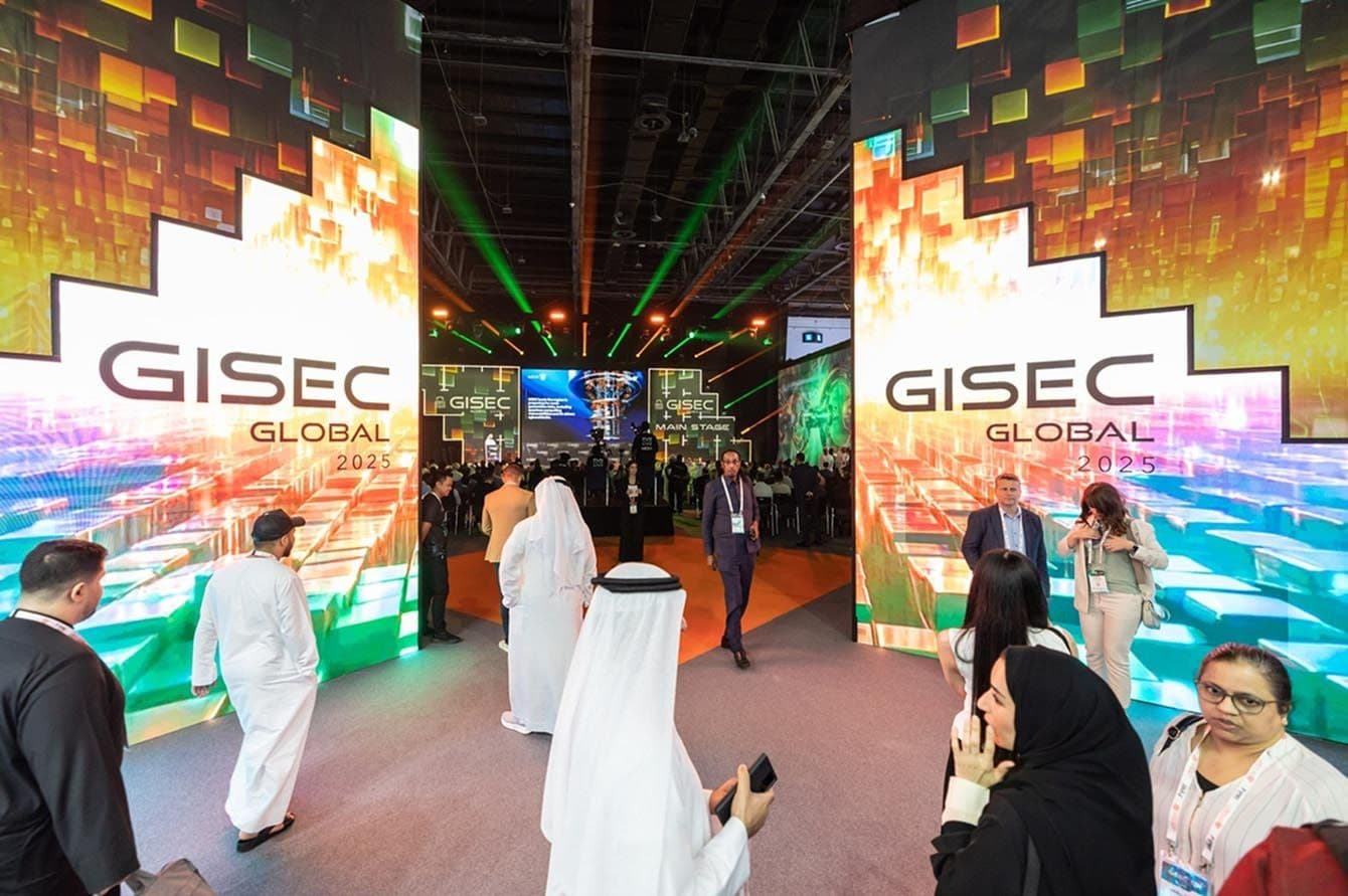 Visitors walking through a GISEC Global exhibition entrance.