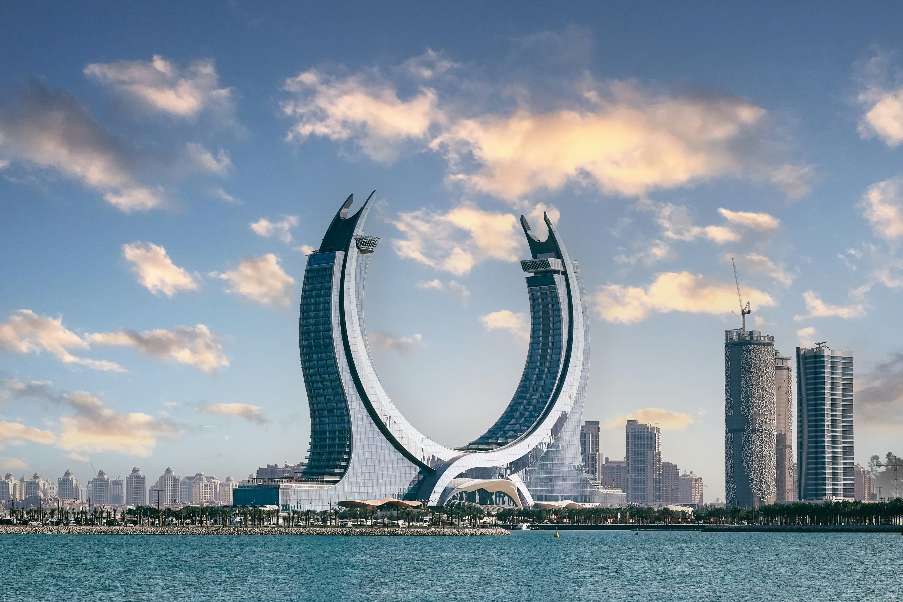 Lusail waterfront towers under a partly cloudy sky.