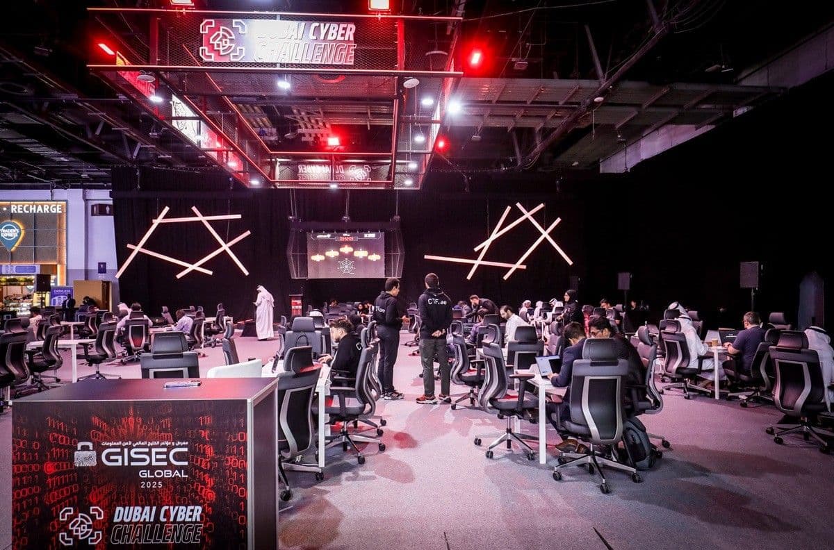 GISEC exhibition space with visitors, equipment, and illuminated displays.