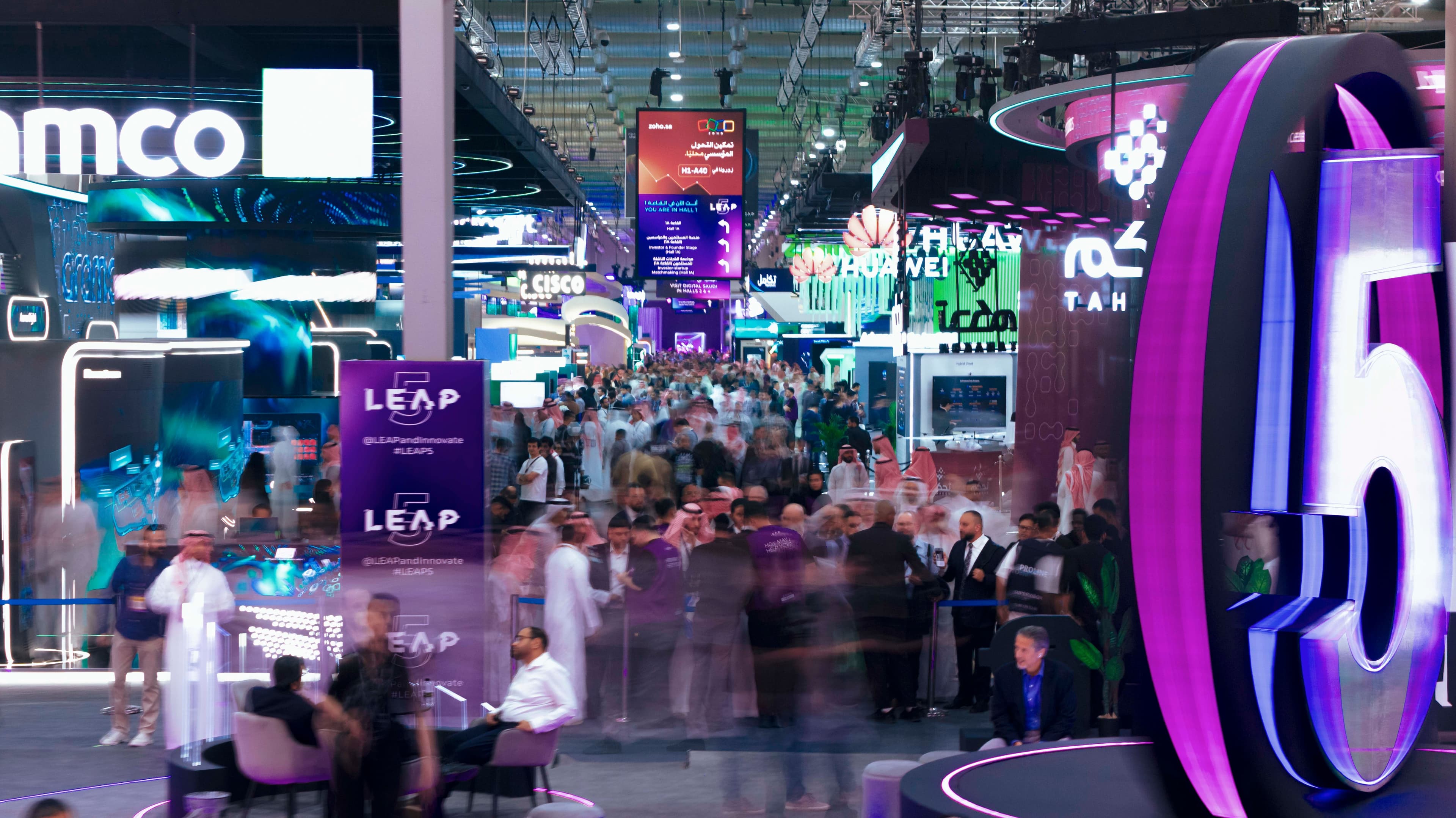 Visitors and displays at a LEAP technology exhibition.