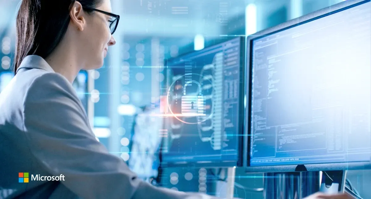 Woman looking at large digital monitors in a Microsoft-branded image.